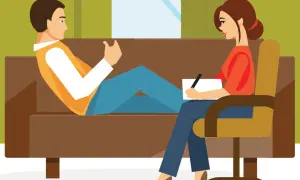 Un hombre habla con una psicóloga que toma notas. La escena ilustra la transferencia en psicología, un proceso clave en la terapia.