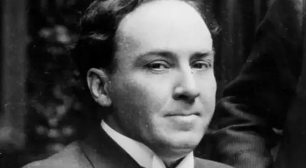 Retrato de un hombre con traje y corbata, evoca las profundas frases de Antonio Machado sobre el tiempo y la vida.