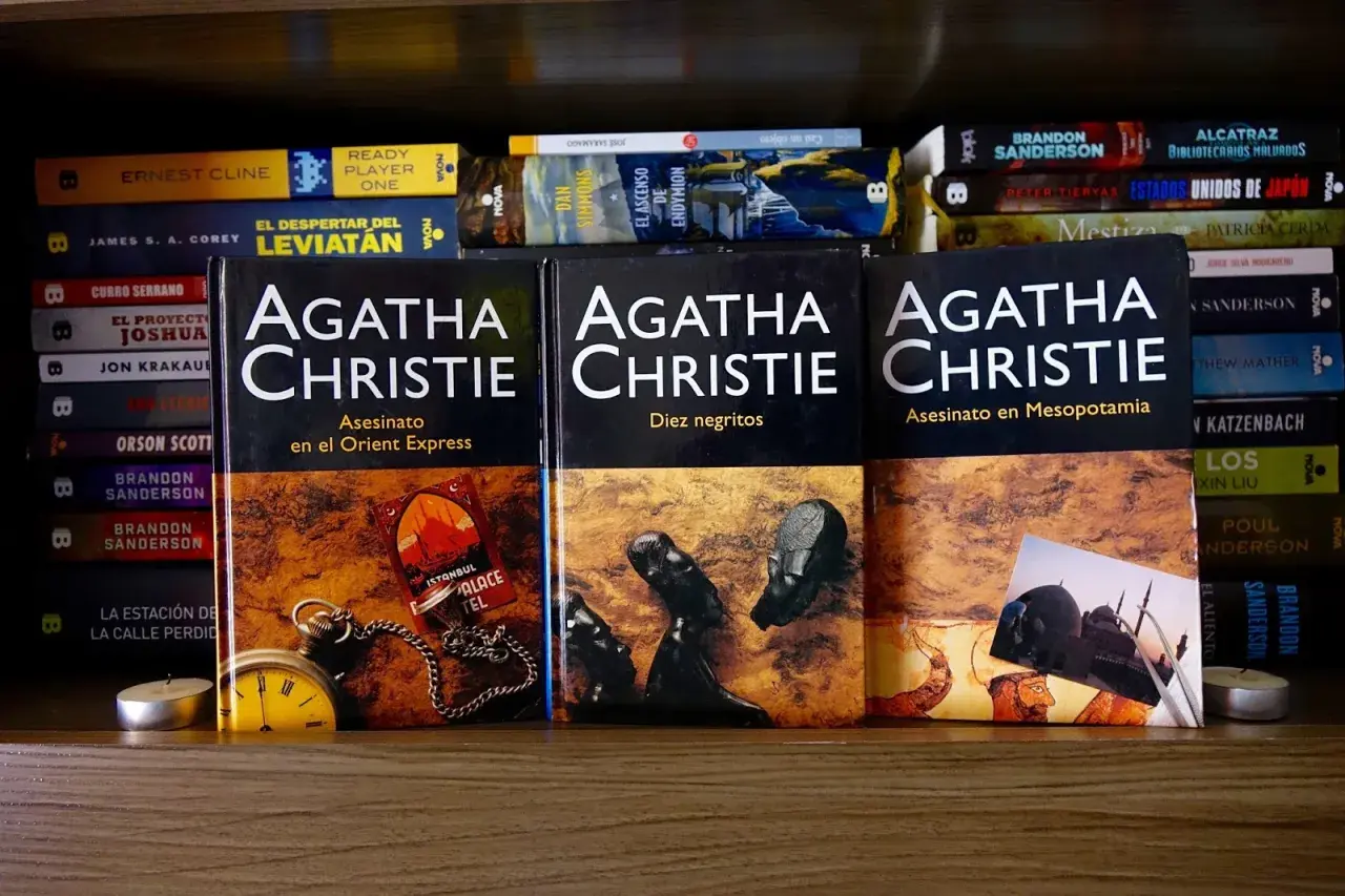 Estantería con varias obras de Agatha Christie, incluyendo "Asesinato en el Orient Express" y "Diez negritos", junto a otros libros.