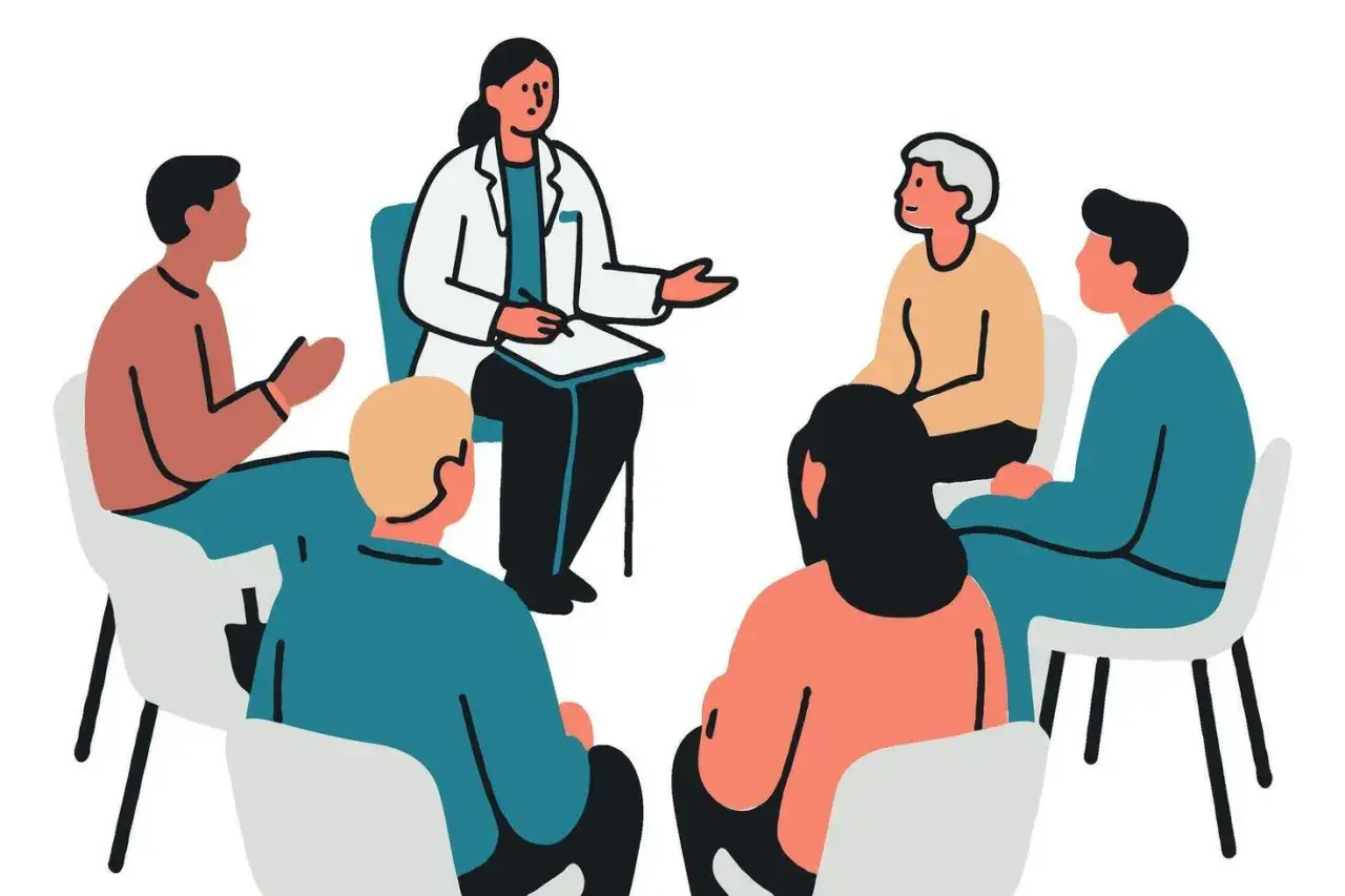 Grupo de apoyo discutiendo la distimia que es, con un terapeuta guiando la conversaci&oacute;n.