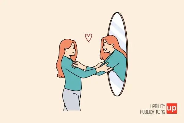 Una mujer se abraza a sí misma frente a un espejo, reflejando el verdadero autoestima significado. Un corazón rojo simboliza el amor propio.